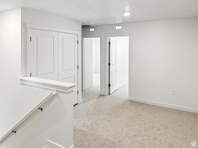 8239 W Joshua Tree Ln, Magna, UT 84044 - corridor with light colored carpet and baseboards
