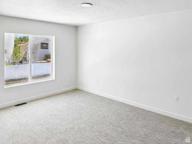 8239 W Joshua Tree Ln, Magna, UT 84044 - spare room with a textured ceiling and carpet floors