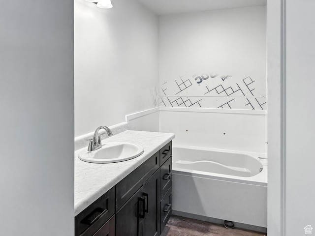 8239 W Joshua Tree Ln, Magna, UT 84044 - bathroom with a bath, vanity, and wood finished floors