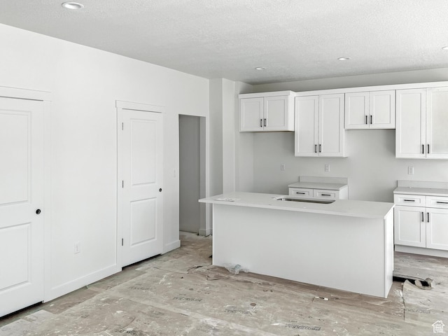 8239 W Joshua Tree Ln, Magna, UT 84044 - kitchen featuring a textured ceiling, white cabinetry, a kitchen island, and recessed lighting