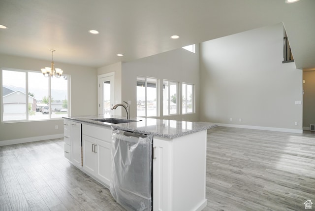 3045 S 2275 W, West Haven, UT 84401 - kitchen with dishwasher, a chandelier, light wood-style flooring, a kitchen island with sink, and white cabinets