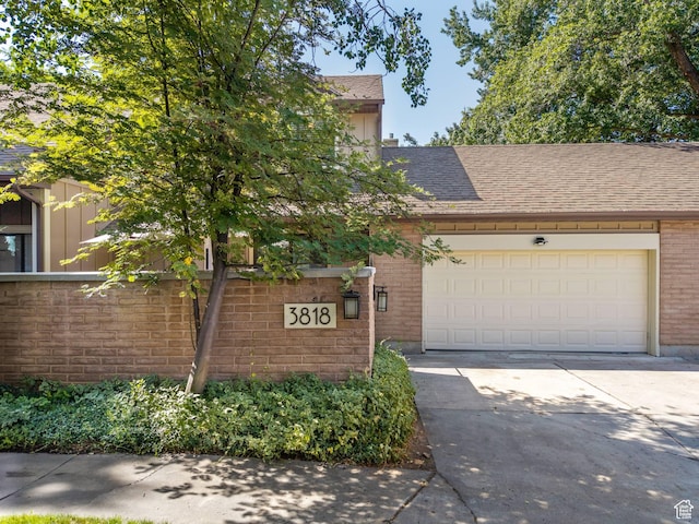 3818 N Little Rock Ct E, Provo, UT 84604 - view of front of property with brick siding, driveway, a shingled roof, an attached garage, and board and batten siding