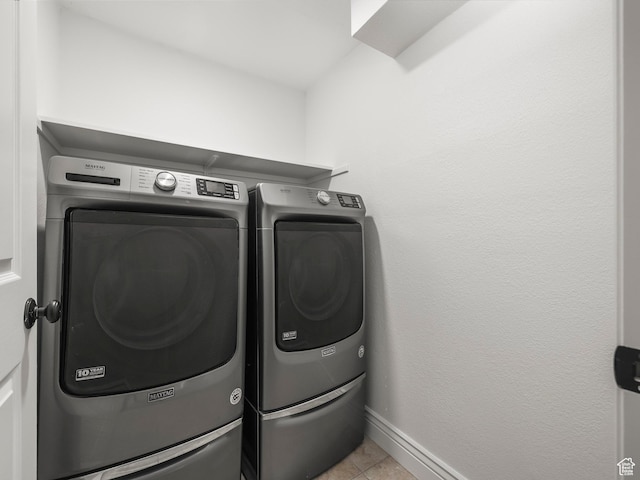 3818 N Little Rock Ct E, Provo, UT 84604 - laundry room with washer and clothes dryer and light tile patterned floors