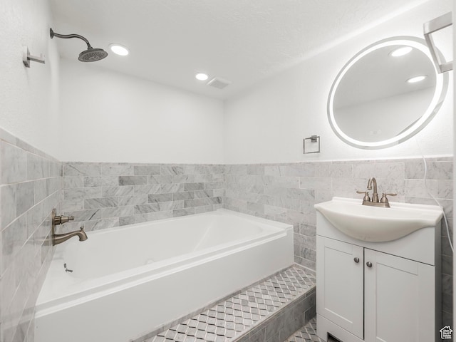 3818 N Little Rock Ct E, Provo, UT 84604 - bathroom with vanity, a garden tub, tile walls, recessed lighting, and wainscoting