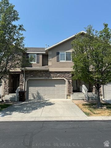 12228 S Madison View Dr, Riverton, UT 84065 - view of front of home featuring stone siding, driveway, a garage, and stucco siding