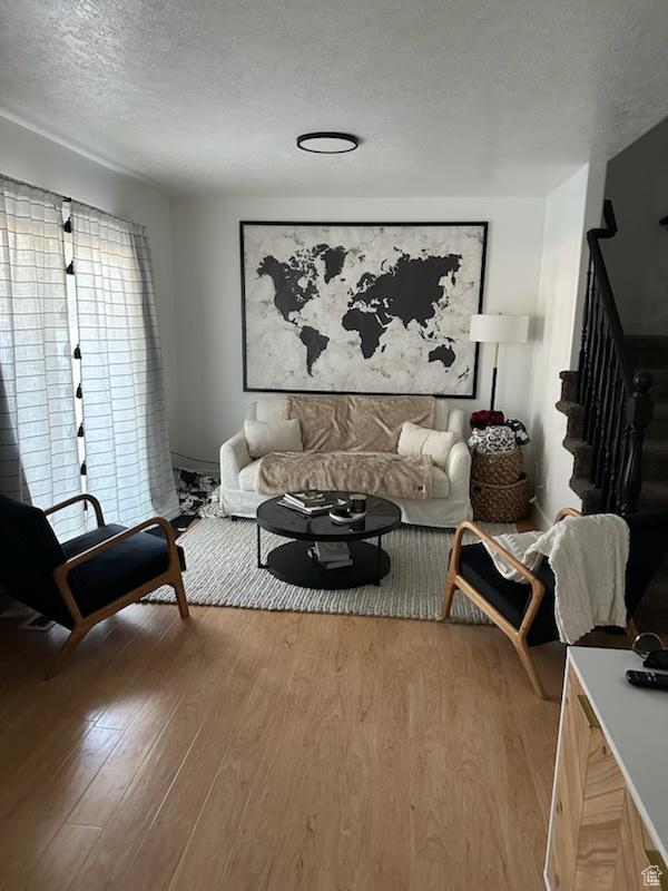 12228 S Madison View Dr, Riverton, UT 84065 - living room featuring a textured ceiling, wood finished floors, and stairway