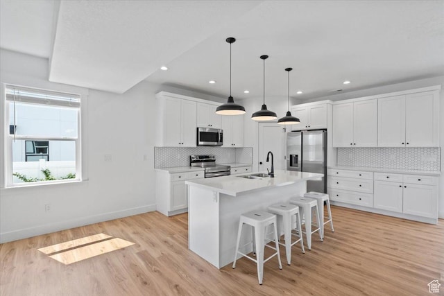 723 W 800 S, Springville, UT 84663 - kitchen with stainless steel appliances, a breakfast bar area, white cabinetry, tasteful backsplash, and recessed lighting