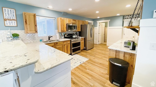 325 S 100 W, Garden City, UT 84028 - kitchen with stainless steel appliances, light wood-style floors, decorative backsplash, recessed lighting, and light stone countertops