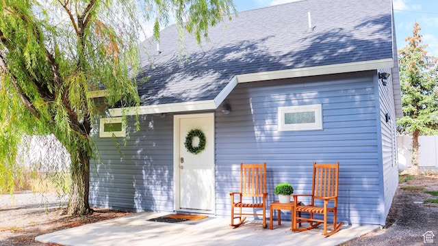 325 S 100 W, Garden City, UT 84028 - view of front of house featuring a shingled roof and a patio area