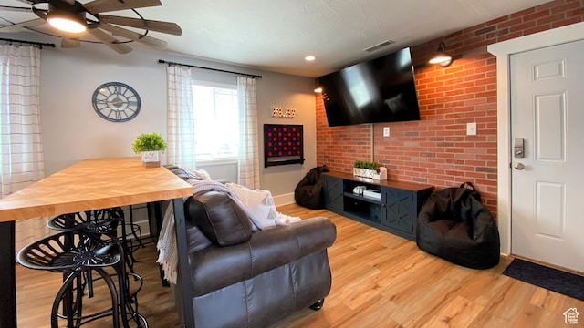 325 S 100 W, Garden City, UT 84028 - living area featuring a ceiling fan, wood finished floors, recessed lighting, and brick wall