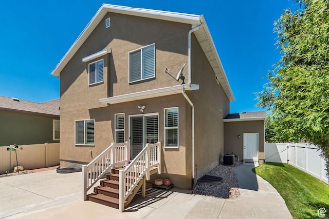 5319 W Elsmere Ln S, Herriman, UT 84096 - rear view of property with a patio area, stucco siding, a fenced backyard, and a gate