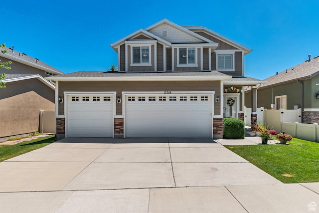5319 W Elsmere Ln S, Herriman, UT 84096 - craftsman inspired home with concrete driveway, an attached garage, and stone siding