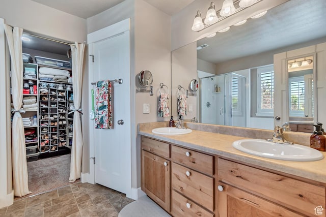 5319 W Elsmere Ln S, Herriman, UT 84096 - bathroom with a shower stall, a spacious closet, double vanity, and stone finish floors