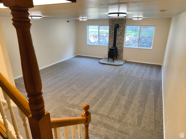 411 S Ridge Rd, Cedar City, UT 84720 - unfurnished living room featuring a wood stove and carpet
