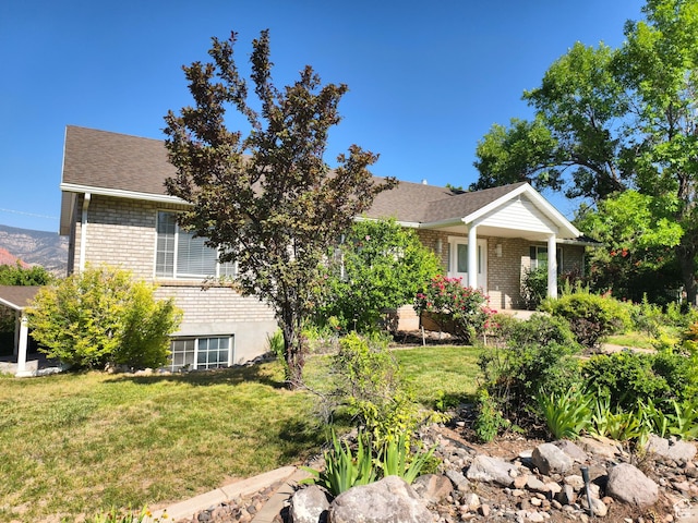 411 S Ridge Rd, Cedar City, UT 84720 - view of property hidden behind natural elements featuring brick siding, a front yard, and roof with shingles