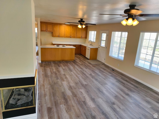 411 S Ridge Rd, Cedar City, UT 84720 - kitchen featuring a ceiling fan, light countertops, wood finished floors, brown cabinetry, and white dishwasher