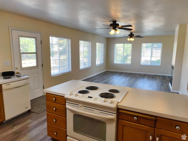 411 S Ridge Rd, Cedar City, UT 84720 - kitchen with white appliances, wood finished floors, brown cabinetry, and light countertops