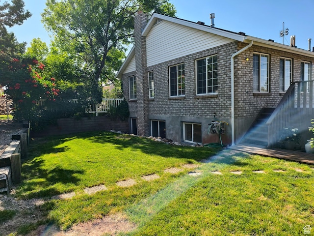 411 S Ridge Rd, Cedar City, UT 84720 - view of side of property with a chimney, a yard, and brick siding