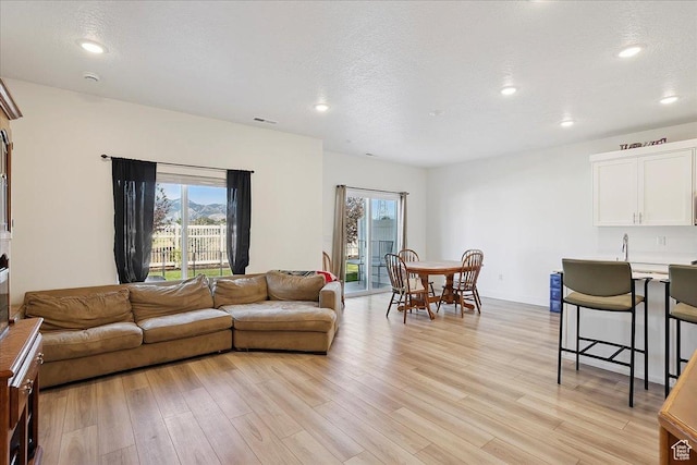 3270 N 3325 W Unit 386B, Plain City, UT 84404 - living room featuring light wood-style flooring, recessed lighting, and a textured ceiling