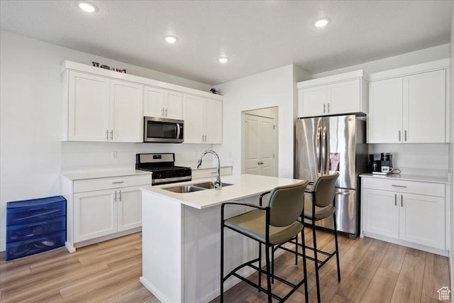 3270 N 3325 W Unit 386B, Plain City, UT 84404 - kitchen with stainless steel appliances, light wood-style floors, white cabinetry, recessed lighting, and a textured ceiling