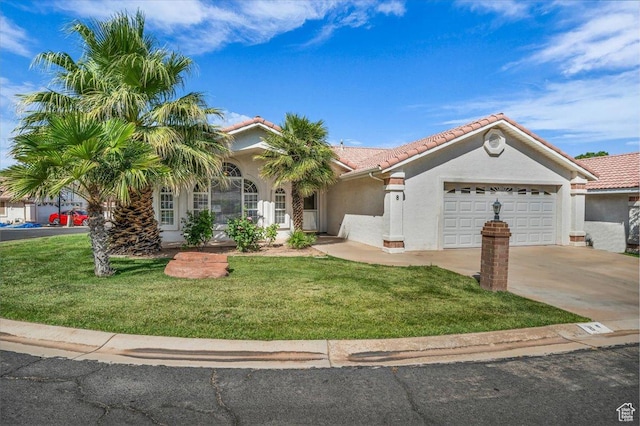 2045 S 1400 E Unit 8, St George, UT 84790 - mediterranean / spanish-style home with an attached garage, a tiled roof, concrete driveway, a front yard, and stucco siding