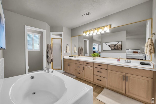 2045 S 1400 E Unit 8, St George, UT 84790 - bathroom featuring double vanity, ensuite bath, a bath, and wood finished floors