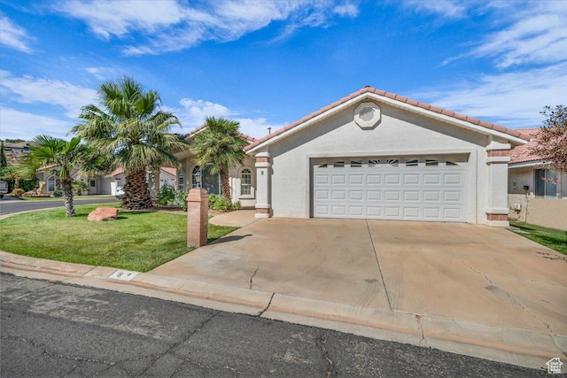 2045 S 1400 E Unit 8, St George, UT 84790 - mediterranean / spanish house featuring a tiled roof, stucco siding, an attached garage, a front yard, and concrete driveway