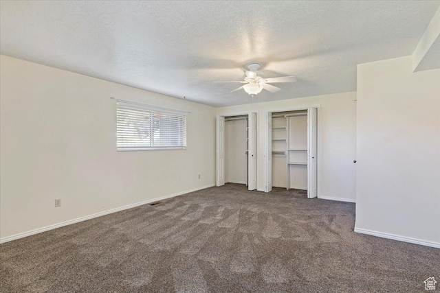 484 E 3450 N, North Ogden, UT 84414 - unfurnished bedroom with two closets, carpet, a textured ceiling, and ceiling fan