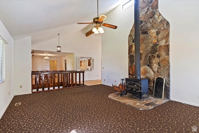 484 E 3450 N, North Ogden, UT 84414 - carpeted living room featuring ceiling fan, a wood stove, and high vaulted ceiling