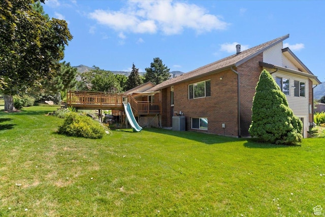 484 E 3450 N, North Ogden, UT 84414 - rear view of house featuring a yard, brick siding, a deck with mountain view, and a playground