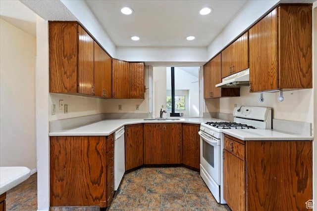 484 E 3450 N, North Ogden, UT 84414 - kitchen featuring white appliances, brown cabinetry, under cabinet range hood, light countertops, and recessed lighting