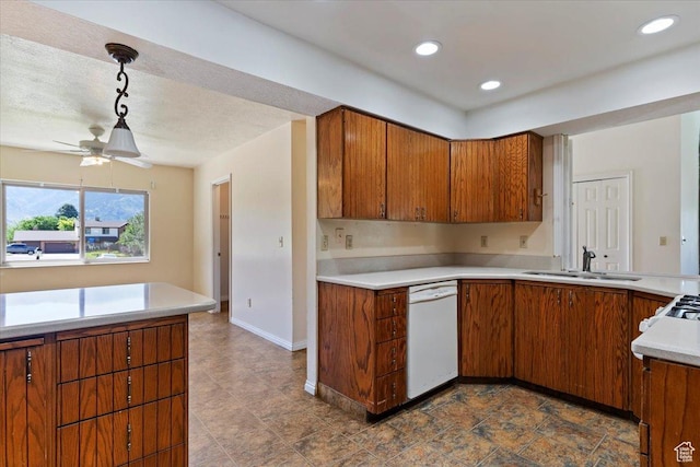 484 E 3450 N, North Ogden, UT 84414 - kitchen featuring dishwasher, brown cabinetry, light countertops, a ceiling fan, and hanging light fixtures