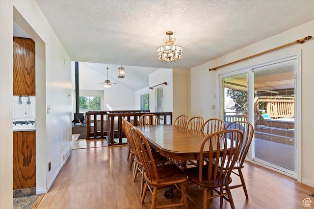 484 E 3450 N, North Ogden, UT 84414 - dining area featuring light wood finished floors, a textured ceiling, a chandelier, and lofted ceiling
