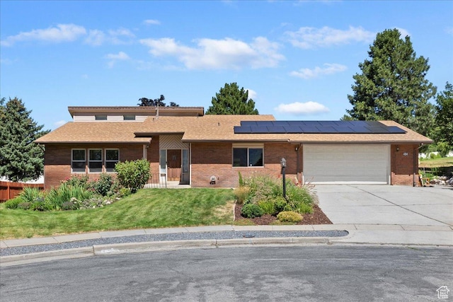 484 E 3450 N, North Ogden, UT 84414 - single story home featuring brick siding, concrete driveway, solar panels, and a front yard