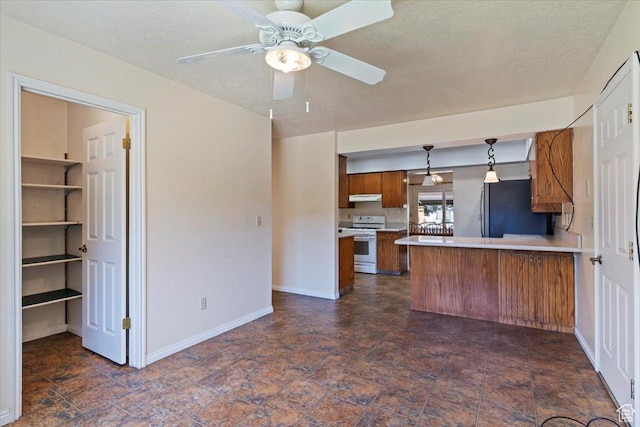 484 E 3450 N, North Ogden, UT 84414 - kitchen featuring white range oven, brown cabinetry, freestanding refrigerator, light countertops, and under cabinet range hood
