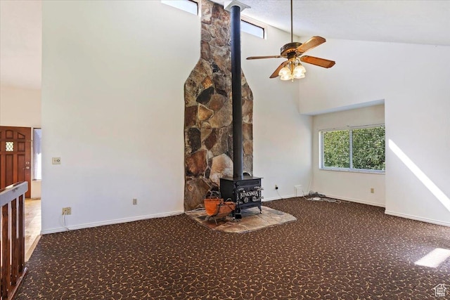 484 E 3450 N, North Ogden, UT 84414 - unfurnished living room with a wood stove, high vaulted ceiling, carpet floors, and a ceiling fan