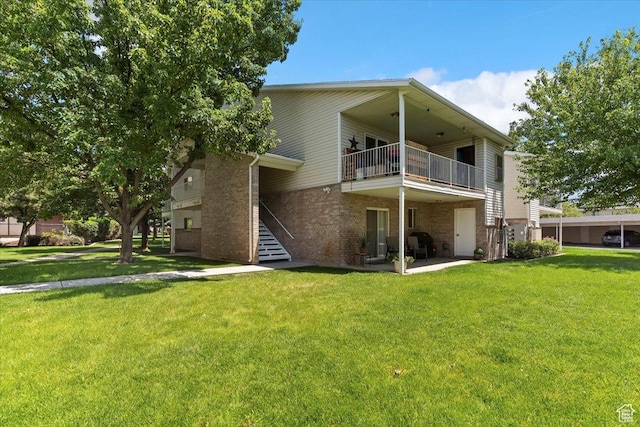 2421 N 400 E Unit C4, North Ogden, UT 84414 - back of house featuring a balcony, brick siding, a lawn, and stairs