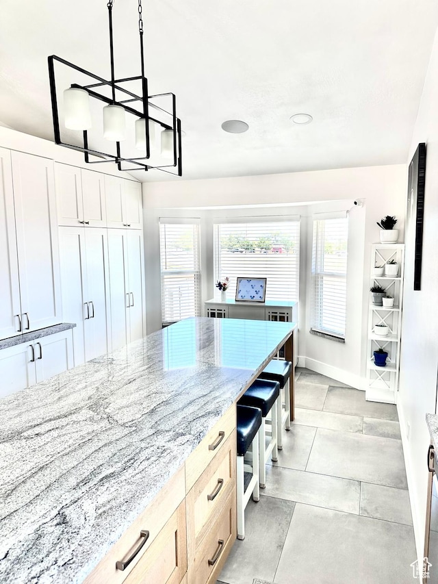 4086 W Wind River Dr, West Jordan, UT 84088 - kitchen with plenty of natural light, a chandelier, light stone countertops, and pendant lighting