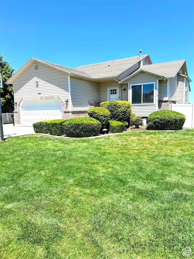 4086 W Wind River Dr, West Jordan, UT 84088 - ranch-style home with brick siding, a garage, and roof with shingles
