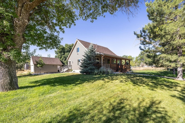 9115 W 25800 N, Portage, UT 84331 - view of property exterior with covered porch, a yard, and an outbuilding