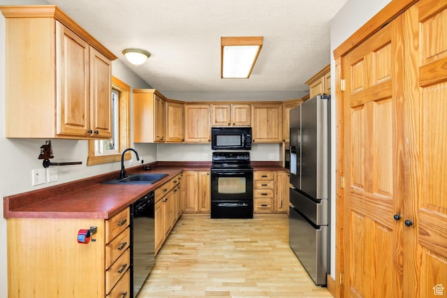 9115 W 25800 N, Portage, UT 84331 - kitchen featuring black appliances, dark countertops, light wood-style flooring, and light brown cabinetry