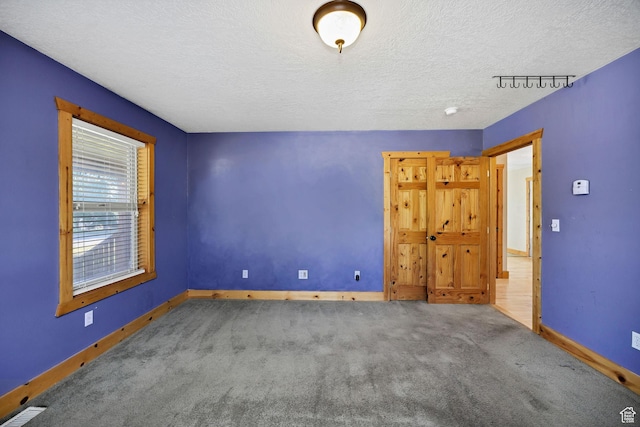 9115 W 25800 N, Portage, UT 84331 - unfurnished bedroom featuring carpet flooring and a textured ceiling