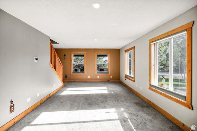 9115 W 25800 N, Portage, UT 84331 - unfurnished living room with plenty of natural light, stairs, carpet flooring, and recessed lighting