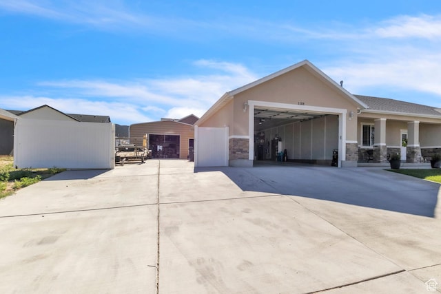 1188 N 100 E, Nephi, UT 84648 - view of front of home featuring concrete driveway, stucco siding, stone siding, and a garage
