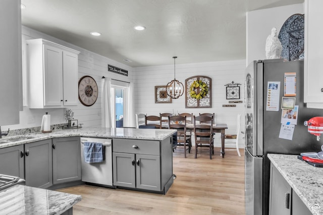 1188 N 100 E, Nephi, UT 84648 - kitchen with appliances with stainless steel finishes, a peninsula, gray cabinets, light wood finished floors, and a chandelier