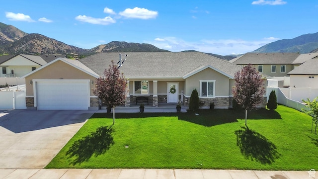 1188 N 100 E, Nephi, UT 84648 - view of front of home featuring stone siding, a porch, a mountain view, concrete driveway, and stucco siding