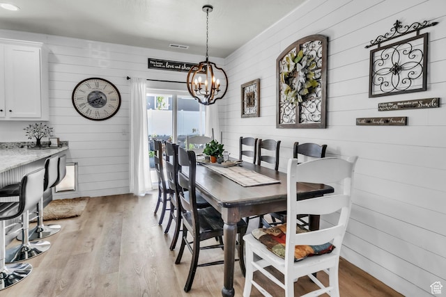 1188 N 100 E, Nephi, UT 84648 - dining area with wooden walls, a chandelier, and light wood finished floors