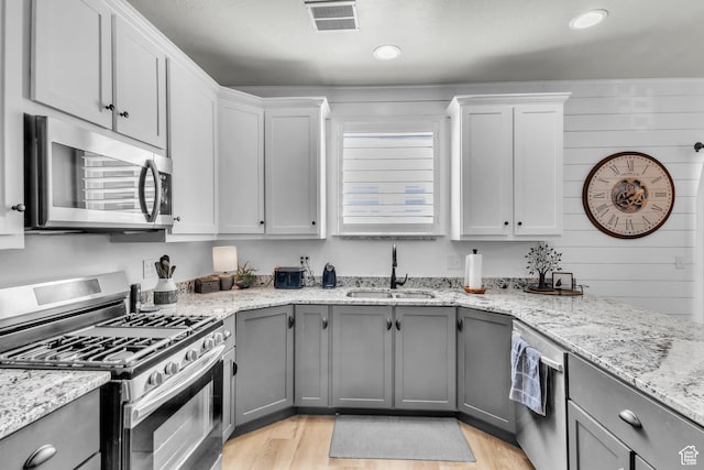 1188 N 100 E, Nephi, UT 84648 - kitchen with appliances with stainless steel finishes, gray cabinetry, light wood-type flooring, light stone countertops, and recessed lighting