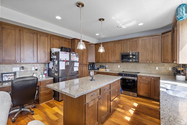 4467 W 5850 S, Hooper, UT 84315 - kitchen with appliances with stainless steel finishes, light wood-type flooring, tasteful backsplash, a center island, and pendant lighting