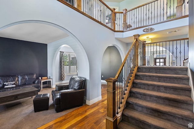 4467 W 5850 S, Hooper, UT 84315 - stairs with wood finished floors, arched walkways, and a towering ceiling